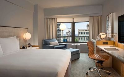 King room with work desk and sofa at New York Hilton Midtown.