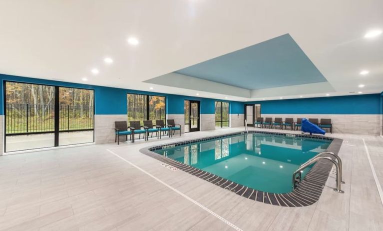 Relaxing indoor heated pool with lounge chairs at Hampton Inn & Suites Benton Harbor.