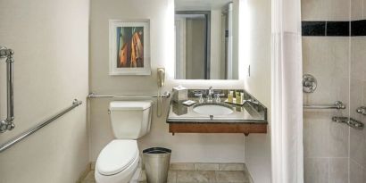 Private guest bathroom with shower and free toiletries at Hilton Minneapolis.