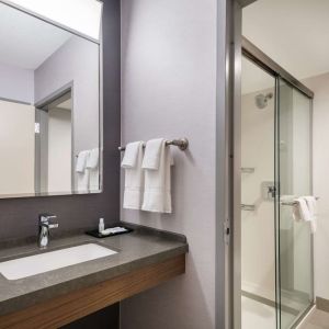 Private guest bathroom with shower and free toiletries at Sonesta Select San Jose Airport.