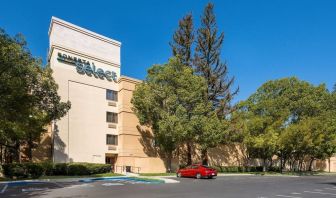 Hotel exterior and parking area at Sonesta Select San Jose Airport.