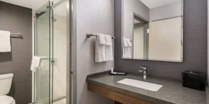 Private guest bathroom with shower at Sonesta Select San Jose Airport.