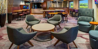 Lobby lounge area and workspace at Sonesta Select Boston Lowell Chelmsford.