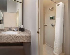 Private guest bathroom with shower and free toiletries at Sonesta Select Allentown Bethlehem Airport.