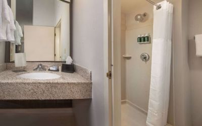 Private guest bathroom with shower and free toiletries at Sonesta Select Allentown Bethlehem Airport.