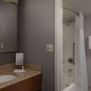 Private guest bathroom with shower and free toiletries at Sonesta Select Chattanooga Hamilton Place.