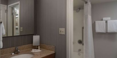 Private guest bathroom with shower and free toiletries at Sonesta Select Chattanooga Hamilton Place.