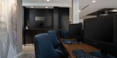 Business center with computers, printer and ergonomic chairs at Sonesta Select Chattanooga Hamilton Place.
