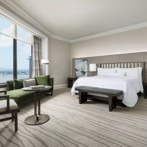 Comfortable king bedroom and a view of the river at The Westin New Orleans.
