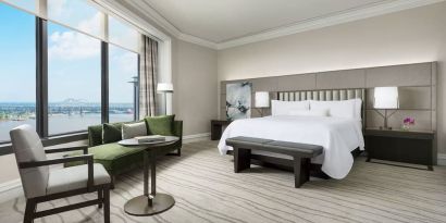 Comfortable king bedroom and a view of the river at The Westin New Orleans.