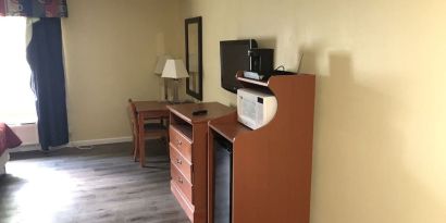 TV and mini-fridge at Quality Inn & Suites Woodstock Near Lake Geneva.