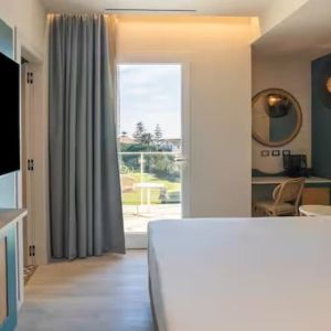 King bed with TV at Terradamari Resort & Spa Marina Di Modica.