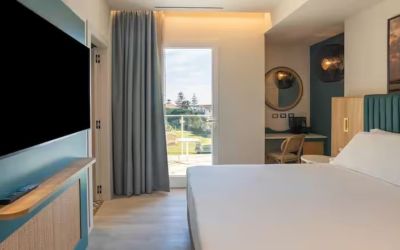 King bed with TV at Terradamari Resort & Spa Marina Di Modica.