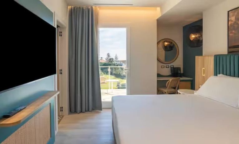 King bed with TV at Terradamari Resort & Spa Marina Di Modica.