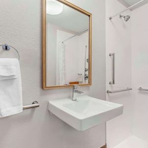 Private guest bathroom with shower and free toiletries at Sonesta Simply Suites Baltimore BWI Airport.