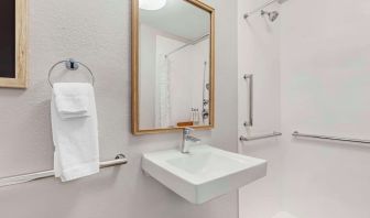 Private guest bathroom with shower and free toiletries at Sonesta Simply Suites Baltimore BWI Airport.