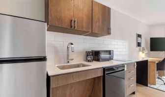 In-room kitchen with fridge, sink and microwave at Sonesta Simply Suites Baltimore BWI Airport. 