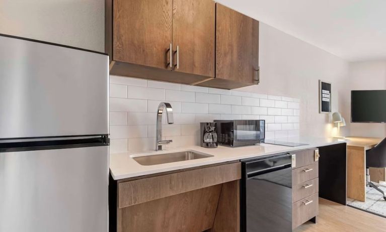 In-room kitchen with fridge, sink and microwave at Sonesta Simply Suites Baltimore BWI Airport. 