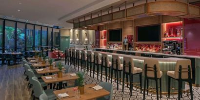 On-site bar with seating and lounge area at Sonesta Miami Airport.