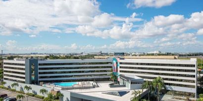 Exterior view of Sonesta Miami Airport and parking area. 