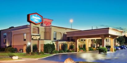 Hotel entrance and parking area at Hampton Inn Columbus-East. 
