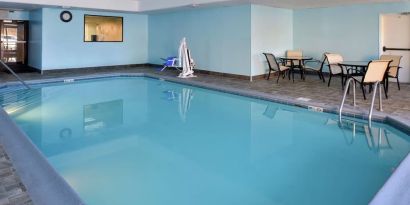 Indoor heated pool with lounge chairs at Hampton Inn Columbus-East.