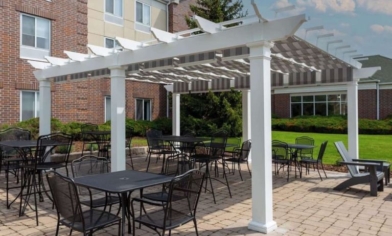 Hotel patio with seating area at Hilton Garden Inn Milwaukee Northwest Conference Center.