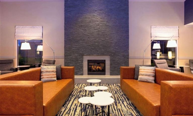 Comfortable lobby lounge with fireplace at Hilton Garden Inn Milwaukee Northwest Conference Center.