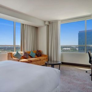 Day use room with work desk and a view of the city at Hilton Dallas/ Plano Granite Park.