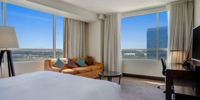 Day use room with work desk and a view of the city at Hilton Dallas/ Plano Granite Park.
