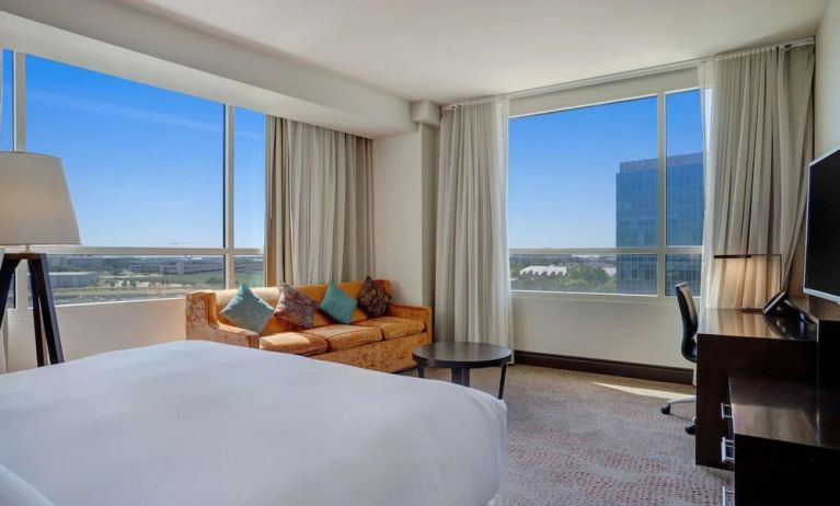 Day use room with work desk and a view of the city at Hilton Dallas/ Plano Granite Park.