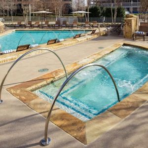 Refreshing outdoor pool and hot tub at Hilton Dallas/ Plano Granite Park.