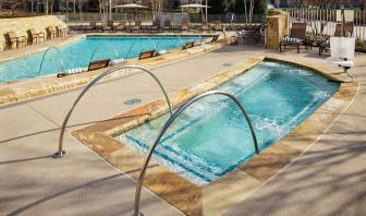 Refreshing outdoor pool and hot tub at Hilton Dallas/ Plano Granite Park.