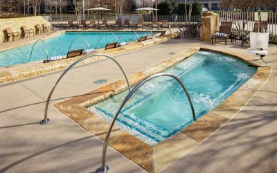 Refreshing outdoor pool and hot tub at Hilton Dallas/ Plano Granite Park.
