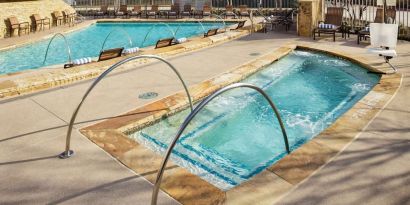 Refreshing outdoor pool and hot tub at Hilton Dallas/ Plano Granite Park.