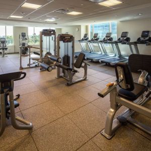 Fitness center with natural light at Hilton Dallas/ Plano Granite Park.