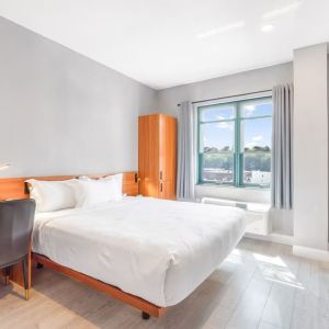 Day use room with work desk and natural light at Liberty View Brooklyn Hotel.
