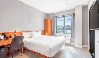 Day use room with work desk and natural light at Liberty View Brooklyn Hotel.
