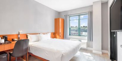 Day use room with work desk and natural light at Liberty View Brooklyn Hotel.
