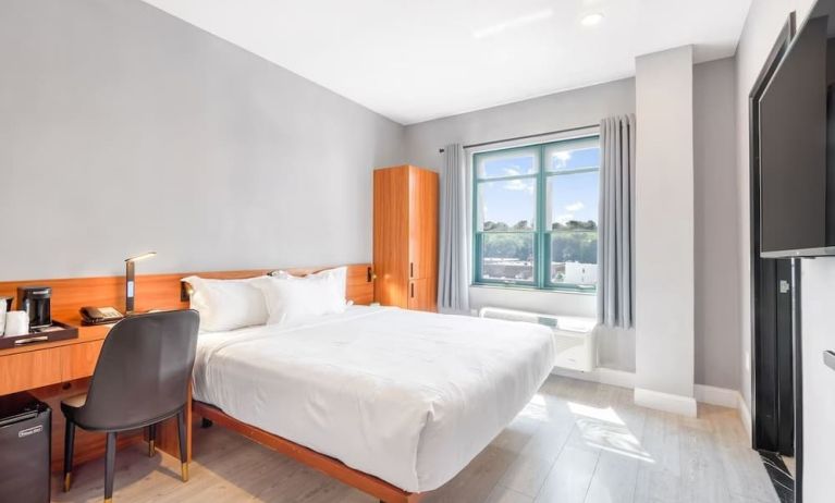 Day use room with work desk and natural light at Liberty View Brooklyn Hotel.
