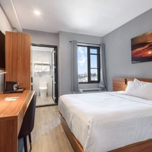 Day use room with work desk and natural light at Liberty View Brooklyn Hotel.
