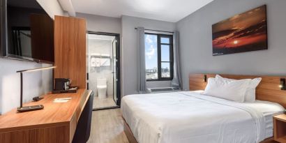 Day use room with work desk and natural light at Liberty View Brooklyn Hotel.