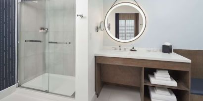 Guest bathroom with shower at The Chifley Houston, Tapestry Collection By Hilton.