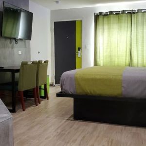 Day use room with TV at Exclusivo Inn & Suites. 