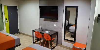 Day use room with TV at Exclusivo Inn & Suites. 