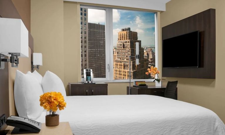 Day use room with work desk, TV screen and private bathroom at Hilton Garden Inn New York/Times Square Central.