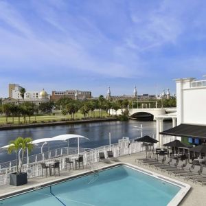 Outdoor pool with lounge area at Hotel Tampa Riverwalk.