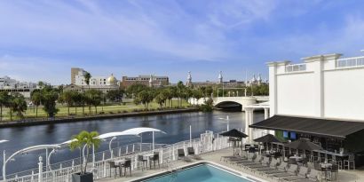 Outdoor pool with lounge area at Hotel Tampa Riverwalk.