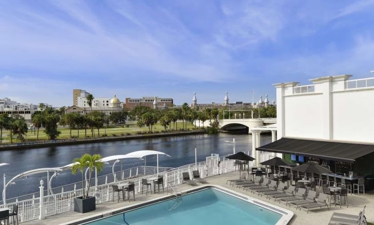 Outdoor pool with lounge area at Hotel Tampa Riverwalk.