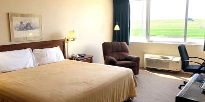 Bright and spacious day use room with work desk and sofa at Norwood Inn And Suites Worthington.